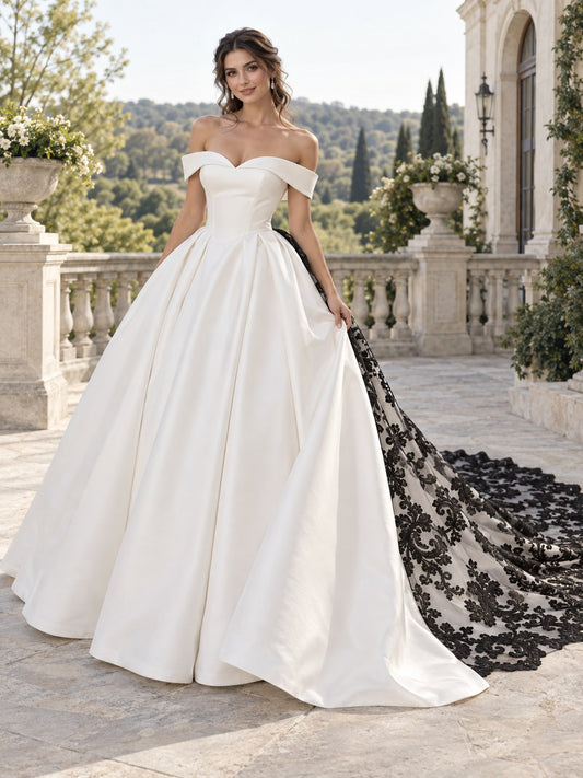 Vestido de novia de satén y encaje en blanco, corte princesa, hombros descubiertos, manga corta y cola capilla