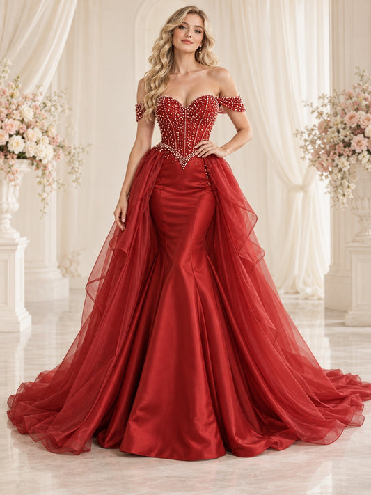 Vestido de novia de satén, tul y organza en rojo, corte sirena, escote corazón y hombros descubiertos y largo hasta el suelo
